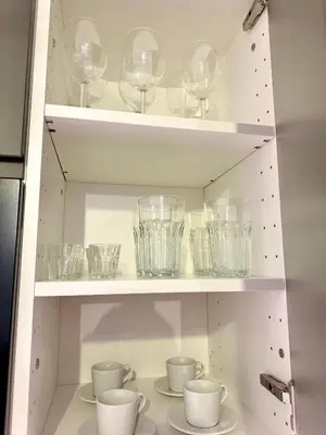 a shelf with glasses and cups on it at Prague Milada & Heaven Home Apartment in Prague