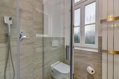 a bathroom with a toilet and a glass shower at Prague Milada & Heaven Home Apartment in Prague
