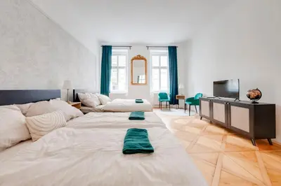 a living room with a large bed and a television at City center premium apartment Bohemia in Prague