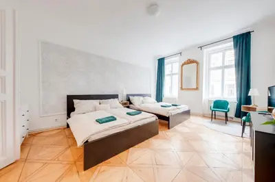 a large bedroom with a bed and a couch at City center premium apartment Bohemia in Prague