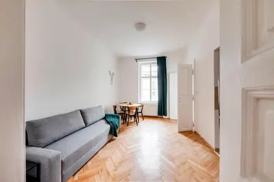 a living room with a couch and a table at City center premium apartment Bohemia in Prague