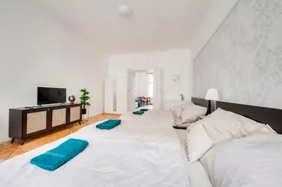 a large white bed with two pillows on top of it at City center premium apartment Bohemia in Prague