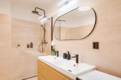 a bathroom with a white sink and a mirror at City center premium apartment Bohemia in Prague