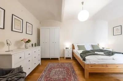 a bedroom with a bed and a dresser and a bed sidx sidx sidx sidx at Prague Days - Two-bedroom Apartment with Workspace and Balcony in Old Town in Prague