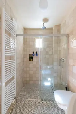 a shower with a glass door in a bathroom at Prague Days - Two-bedroom Apartment with Workspace and Balcony in Old Town in Prague