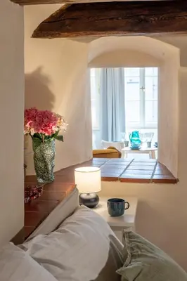 a living room with a vase of flowers on a table at Prague Days - Two-bedroom Apartment with Workspace and Balcony in Old Town in Prague