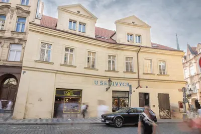 a building with a car parked in front of it at Prague Days - Two-bedroom Apartment with Workspace and Balcony in Old Town in Prague