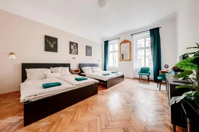 a bedroom with a bed and a living room at City center premium apartment in Prague