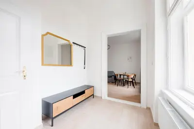 a living room with a mirror and a table at City center premium apartment in Prague