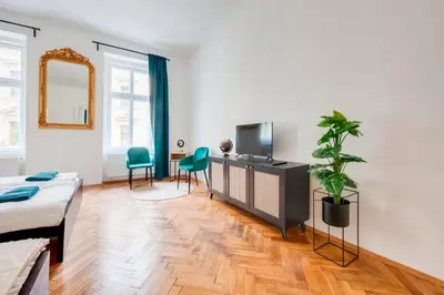 a living room with a couch and a tv at City center premium apartment in Prague