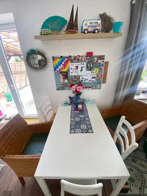 a white table with a vase of flowers on it at Doma na Lipníku-private country house, homestay in Lipník