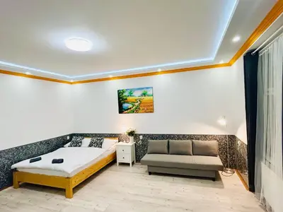 a bedroom with a bed and a couch at Modern Spacious Apartment in center Prague in Prague