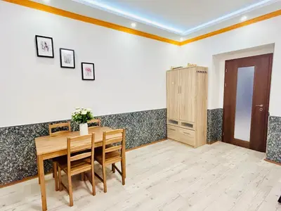 a dining room with a wooden table and chairs at Modern Spacious Apartment in center Prague in Prague