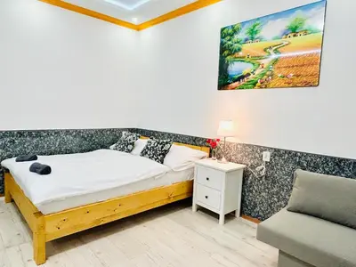 a small bedroom with a bed and a couch at Modern Spacious Apartment in center Prague in Prague