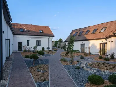 a courtyard in a house with a path between two buildings at Glamping pospolu in Mokrovraty