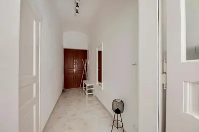 a hallway with white walls and a white door at Premium Apartment Nearby Centre in Prague