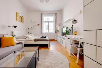 a white living room with a couch and a desk at Premium Apartment Nearby Centre in Prague