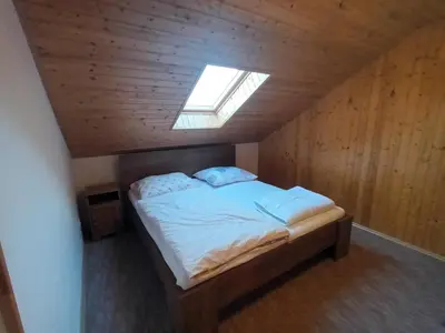 a bedroom with a bed in a wooden ceiling at Apartmán Svaté Pole in Svaté Pole