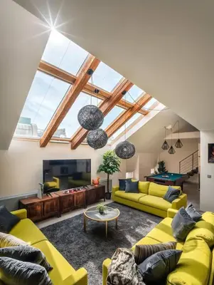 a living room with yellow couches and a pool table at AC Luxury Loft Friends & Family Edition in Prague
