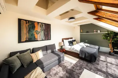 a living room with a couch and a bed at AC Luxury Loft Friends & Family Edition in Prague
