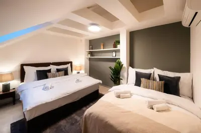 two beds in a room with two beds sidx sidx sidx sidx at AC Luxury Loft Friends & Family Edition in Prague