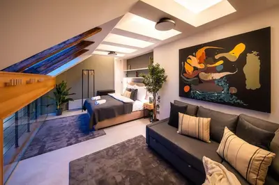 a living room with a couch and a bed at AC Old Town Grand Luxury&Family Loft in Prague