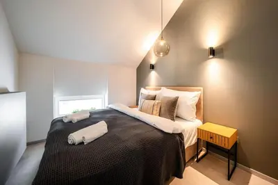 a bedroom with a large bed in a room at AC Old Town Grand Luxury&Family Loft in Prague
