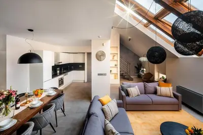 a living room with a couch and a table at AC Old Town Grand Luxury&Family Loft in Prague