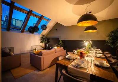 a living room with a long table and a couch at AC Old Town Grand Luxury&Family Loft in Prague