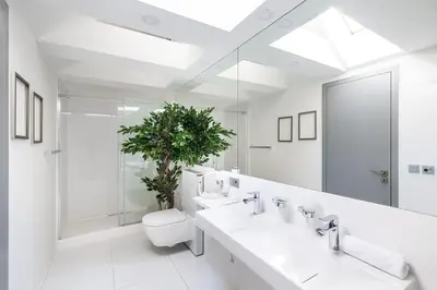 a bathroom with two sinks and a toilet and a plant at AC Old Town Grand Luxury&Family Loft in Prague