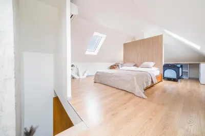 a living room with a dining table and a tv at Apartmán VALORI - 100m2 in Poděbrady