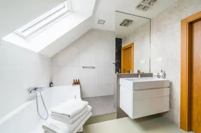 a living room with a tv on a wall at Apartmán VALORI - 100m2 in Poděbrady
