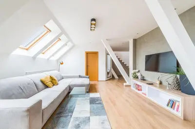a tv sitting on top of a white entertainment center at Apartmán VALORI - 100m2 in Poděbrady