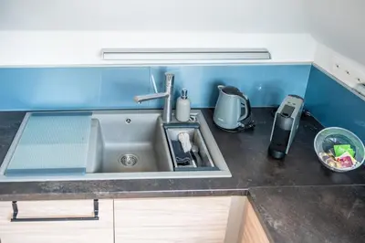 a kitchen with a stove and a counter top at Apartmán VALORI - 100m2 in Poděbrady