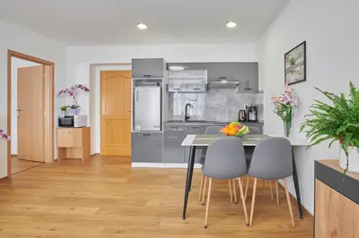 a kitchen with a table and chairs in a room at Apartment Sun & Moon in Prague
