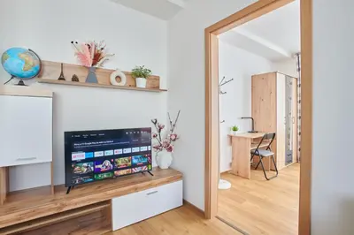 a living room with a mirror and a table at Apartment Sun & Moon in Prague