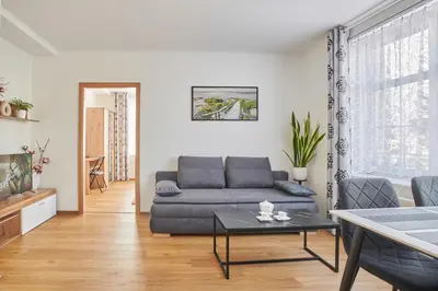 a living room with a couch and a table at Apartment Sun & Moon in Prague