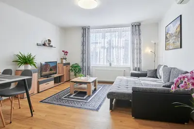 a living room with a couch and a table at Apartment Sun & Moon in Prague