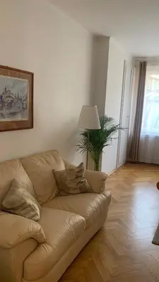 a living room with a brown couch in a living room at Anenska by Charles Bridge 3 in Prague