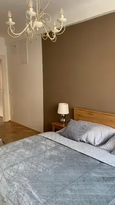 a bedroom with a large bed with a chandelier at Anenska by Charles Bridge 3 in Prague