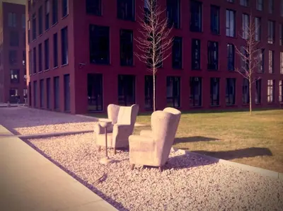 two chairs sitting in front of a building at Cozy apartment fully equipped in Prague