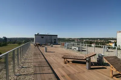 a wooden boardwalk with benches on top of a building at Cozy apartment fully equipped in Prague