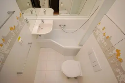 a bathroom with a toilet and a sink and a mirror at Cozy apartment fully equipped in Prague