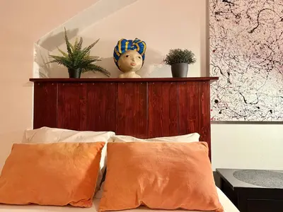 a headboard of a bed with plants on it at Urban downtown studio in Prague