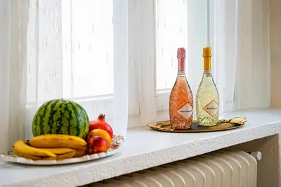 two bottles of wine and fruit on a window sill at Moonlight Deluxe Suite in Prague