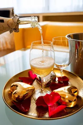 a drink is being poured into a glass on a plate at Moonlight Deluxe Suite in Prague
