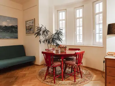 a living room with a red table and chairs at Apartment Art Lounge by Interhome in Prague