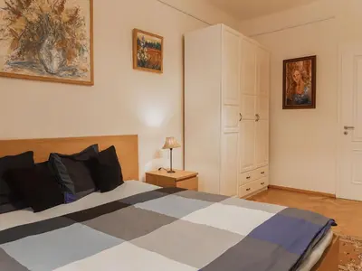 a bedroom with a black and white bed and a cabinet at Apartment Art Lounge by Interhome in Prague