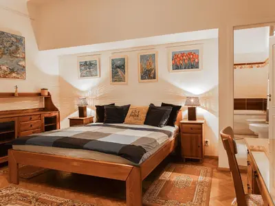 a bedroom with a bed and a tub and a sink at Apartment Art Lounge by Interhome in Prague