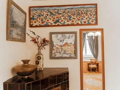 a hallway with paintings on the wall and a vase on a table at Apartment Art Lounge by Interhome in Prague